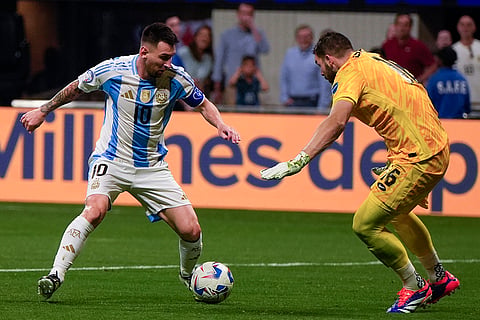 Lionel Messi attempts to dribble past Canada's goalkeeper 